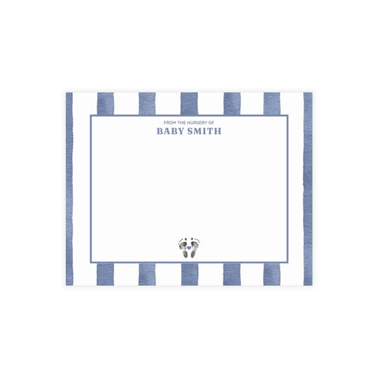 White card with baby footprints, blue and white striped border and text.