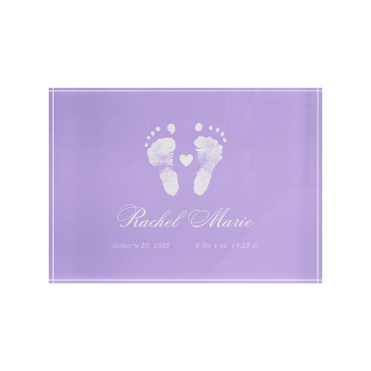 Purple acrylic block with white baby footprints and text.