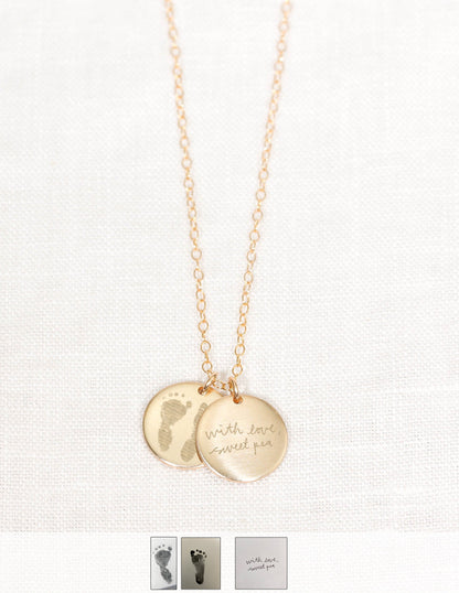 Gold necklace with two round pendants on a white background