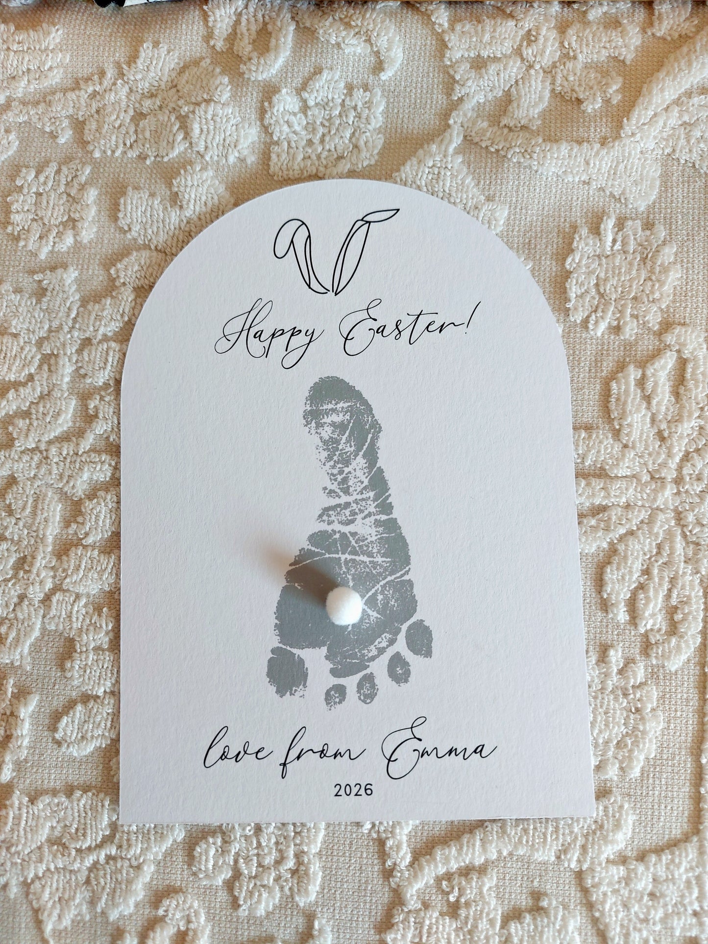 Baby Footprint card with 'Happy Easter!' text on a textured fabric background