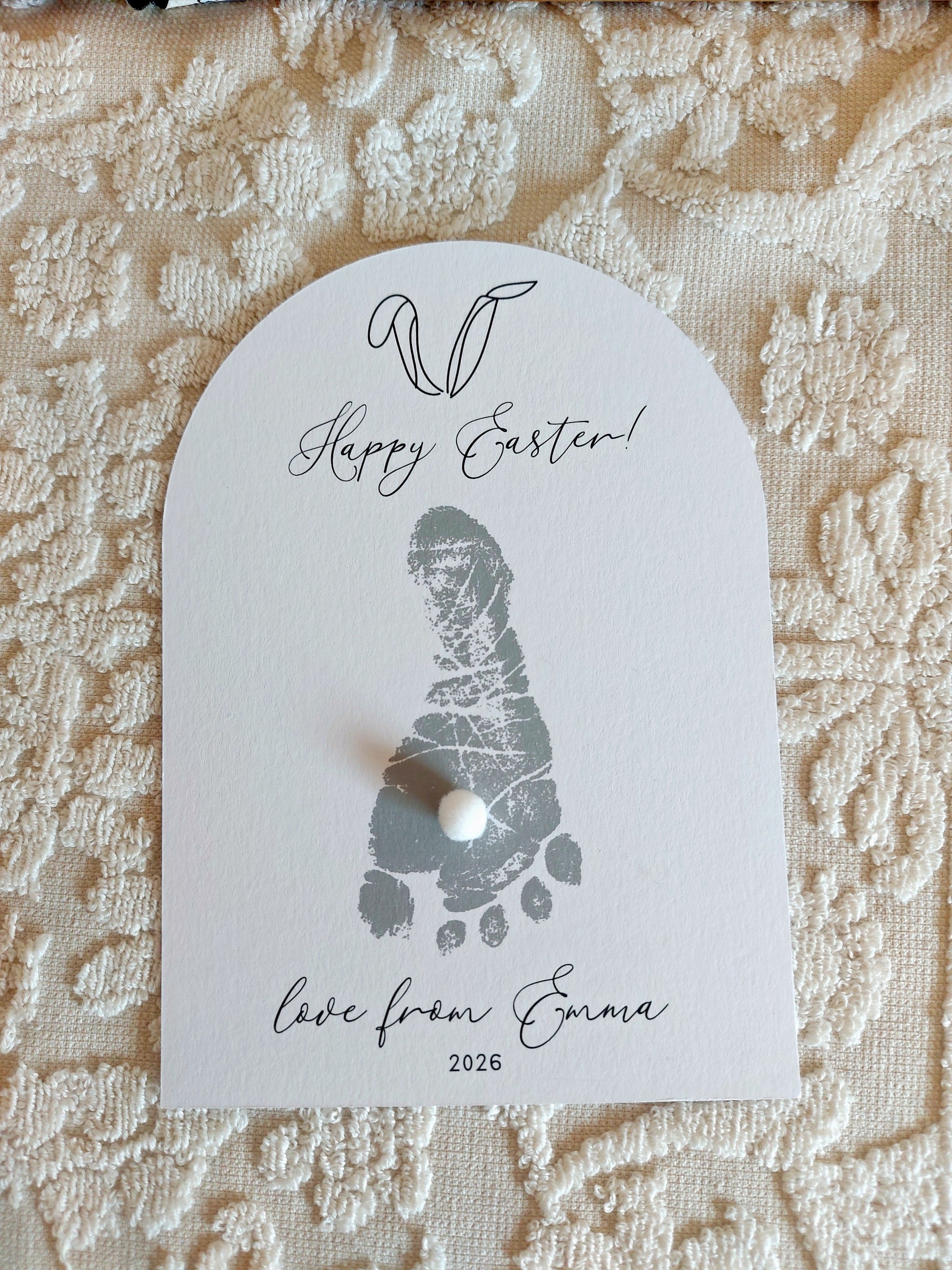 Baby Footprint card with 'Happy Easter!' text on a textured fabric background