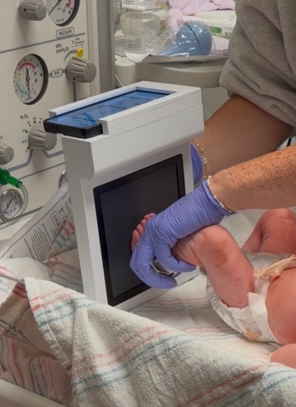 First Stamps digital scanner capturing the image of a baby's footprints as part of the keepsake process at the hospital