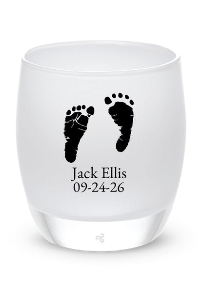 Glassybaby tea candle holder with footprints and text on a white background