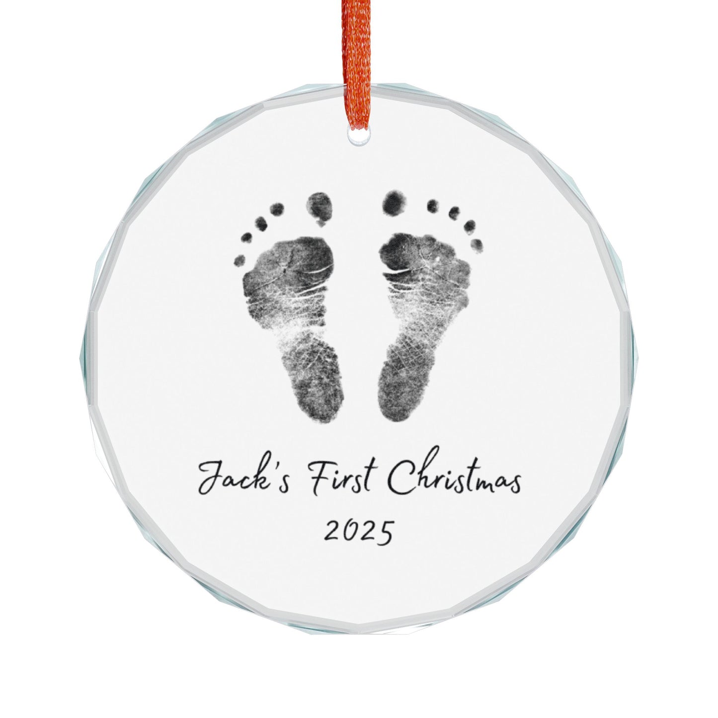 Round glass ornament with personalized baby footprints and 'First Christmas 2025' text on a white background.