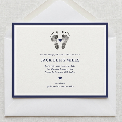 Newborn baby announcement card with footprints and text on a white background