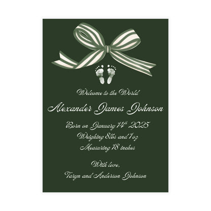 Deep green birth announcement card with a white bow and baby footprint design.