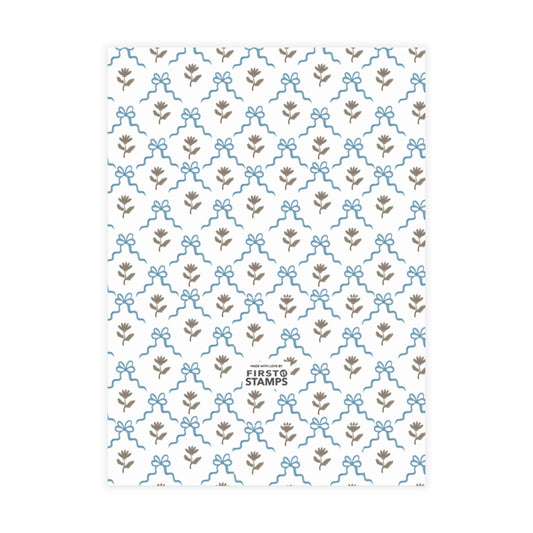 Blue patterned paper with floral and bow design on a white background. First Stamps logo at bottom.