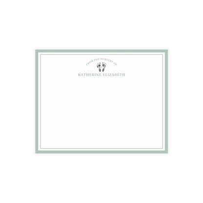 White card with baby footprints, green border and text on a white background
