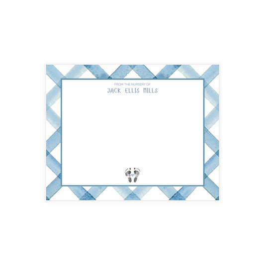 Note card with blue geometric pattern and baby footprints on a white background
