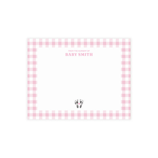 Pink gingham border with baby footprints and text on a white background
