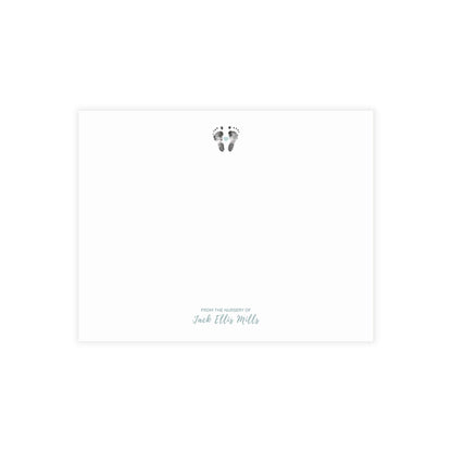 Note card with baby footprints and text on a white background