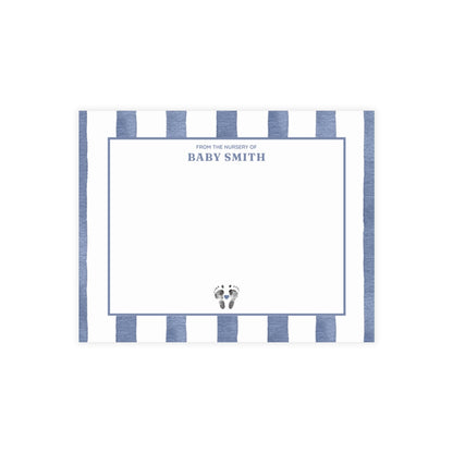 White card with baby footprints, blue and white striped border and text.