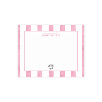 White card with baby footprints, pink and white striped border and text.
