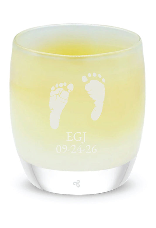 Glassybaby candle with footprints on a white background