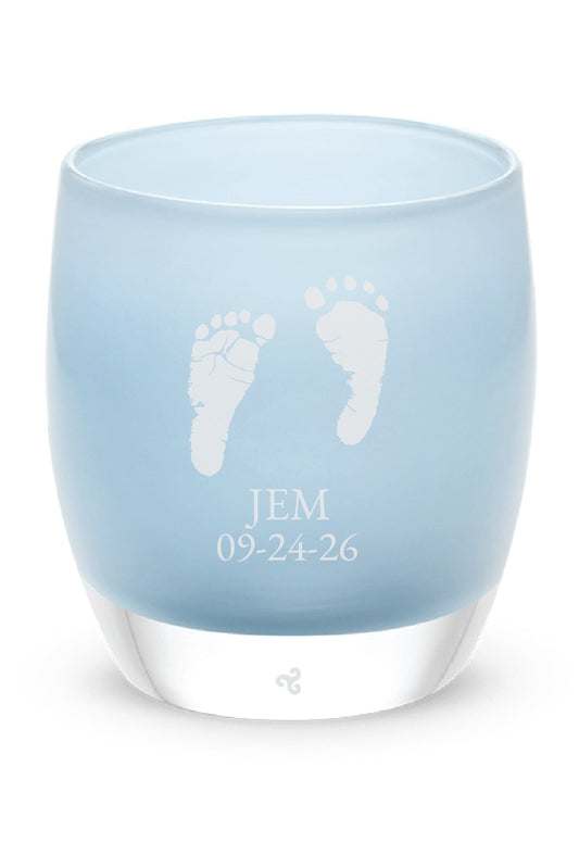 Glassybaby tea light holder with engraved baby feet and name on a white background