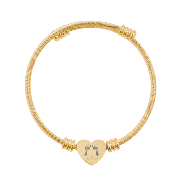 Gold bracelet with a heart-shaped charm featuring footprints on a white background
