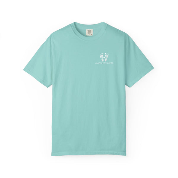 Teal t-shirt with a small baby footprint logo