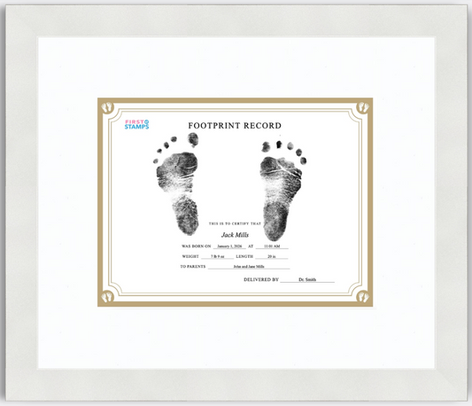 Framed baby footprint record with black and white footprints on a white background